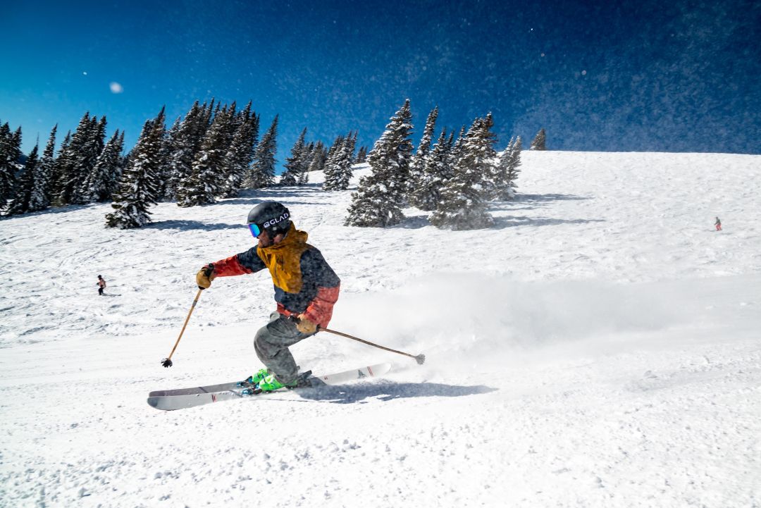 skiier going down ski slope Photo by Glade Optics on Unsplash