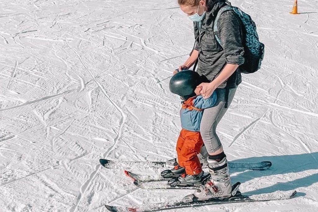 Woman skiing with her toddler