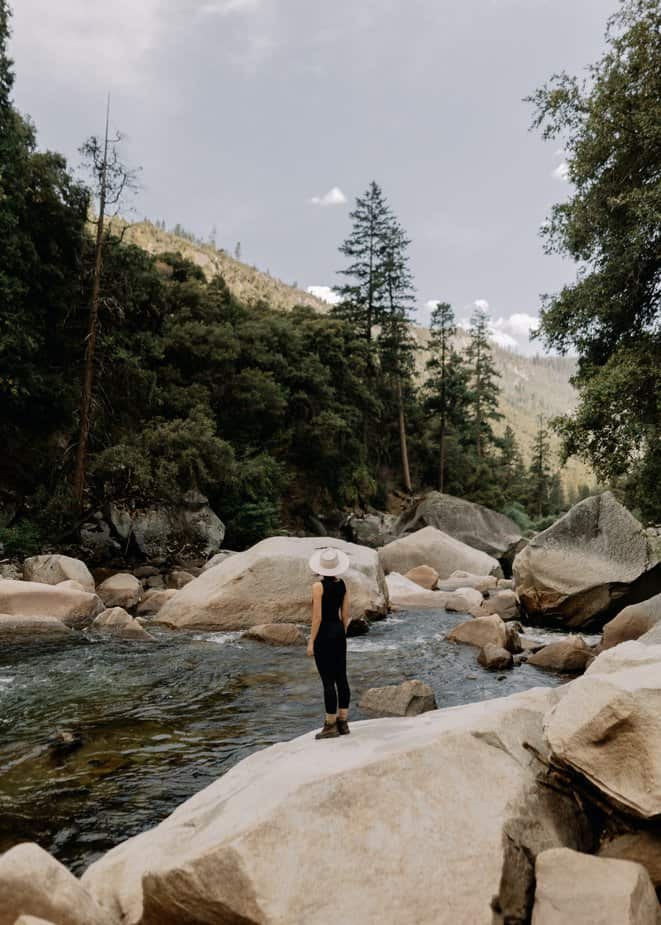 woman-on-stones-on-stream-in-national-park