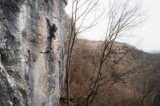 Lead climber on rock wall Photo by Sophie Grieve-Williams on Unsplash